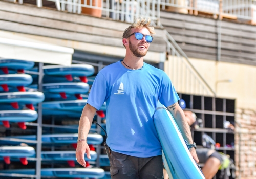 beach sup carrying a sup board